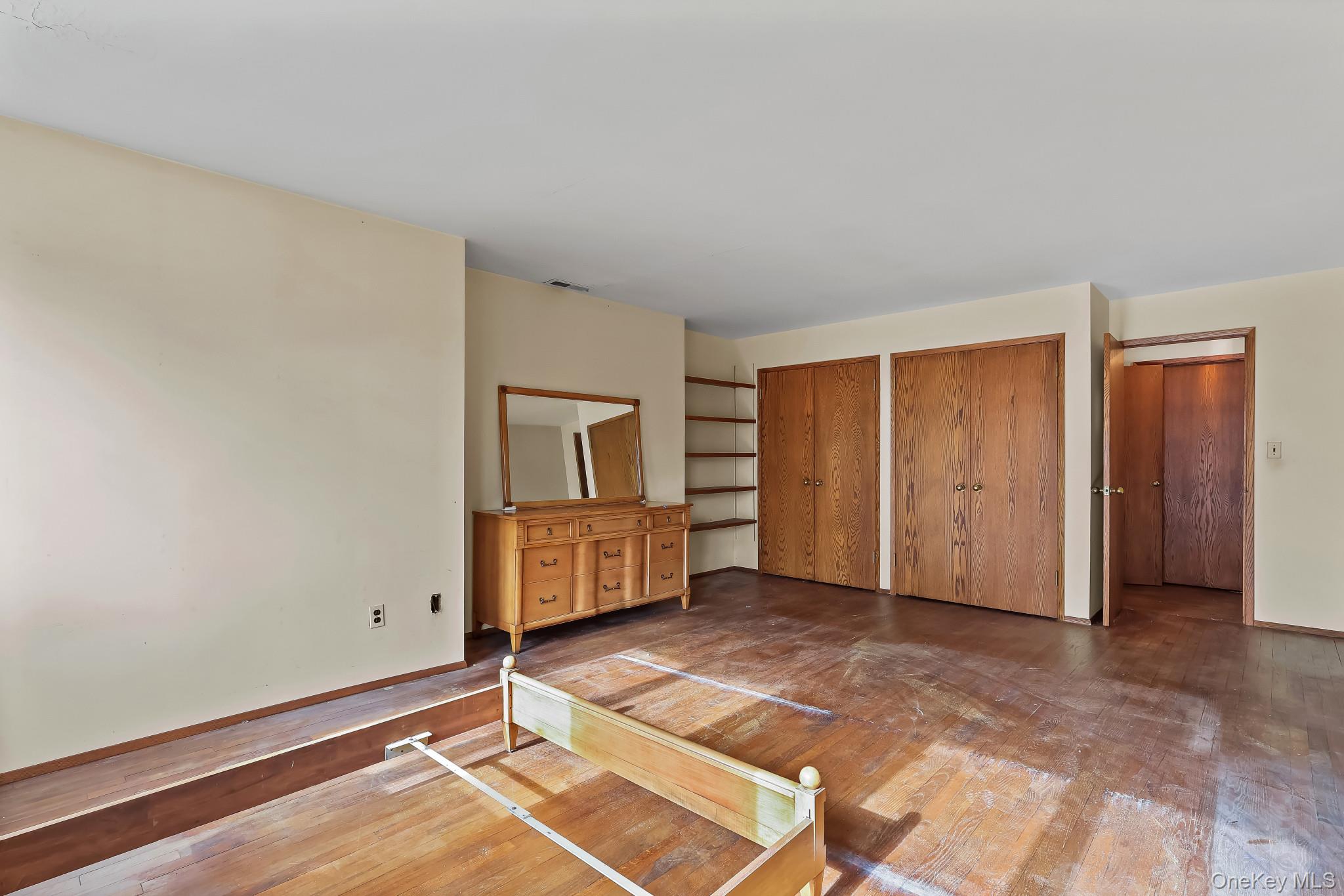 37 Century Trail Harrison, NY 10528 - Photo 30 of 43 Bedroom with hardwood / wood-style flooring and multiple closets