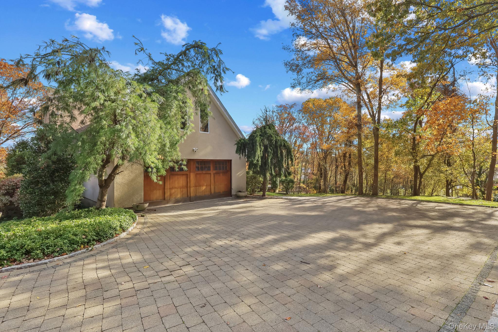 37 Century Trail Harrison, NY 10528 - Photo 5 of 43 View of home's exterior featuring stucco siding and decorative driveway