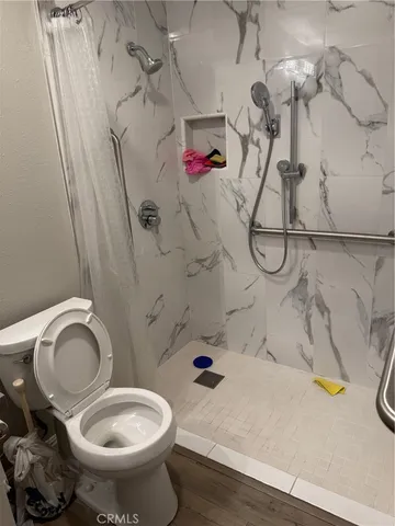 a bathroom with a toilet and a shower