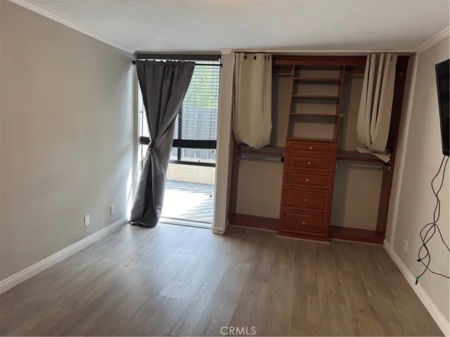an empty room with wooden floor and closet