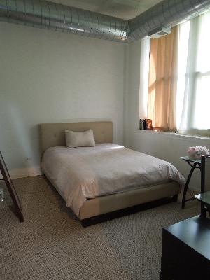 2323 West Pershing Road, Unit 226 Chicago, IL 60609 - Photo 5 of 8 a bedroom with a bed and a night stand