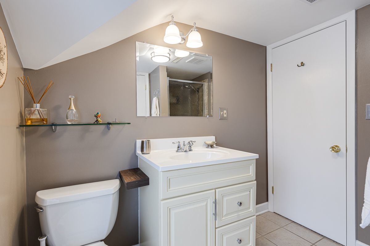 10N849 Rippburger Road Elgin, IL 60124 - Photo 19 of 36 a bathroom with a toilet sink and mirror