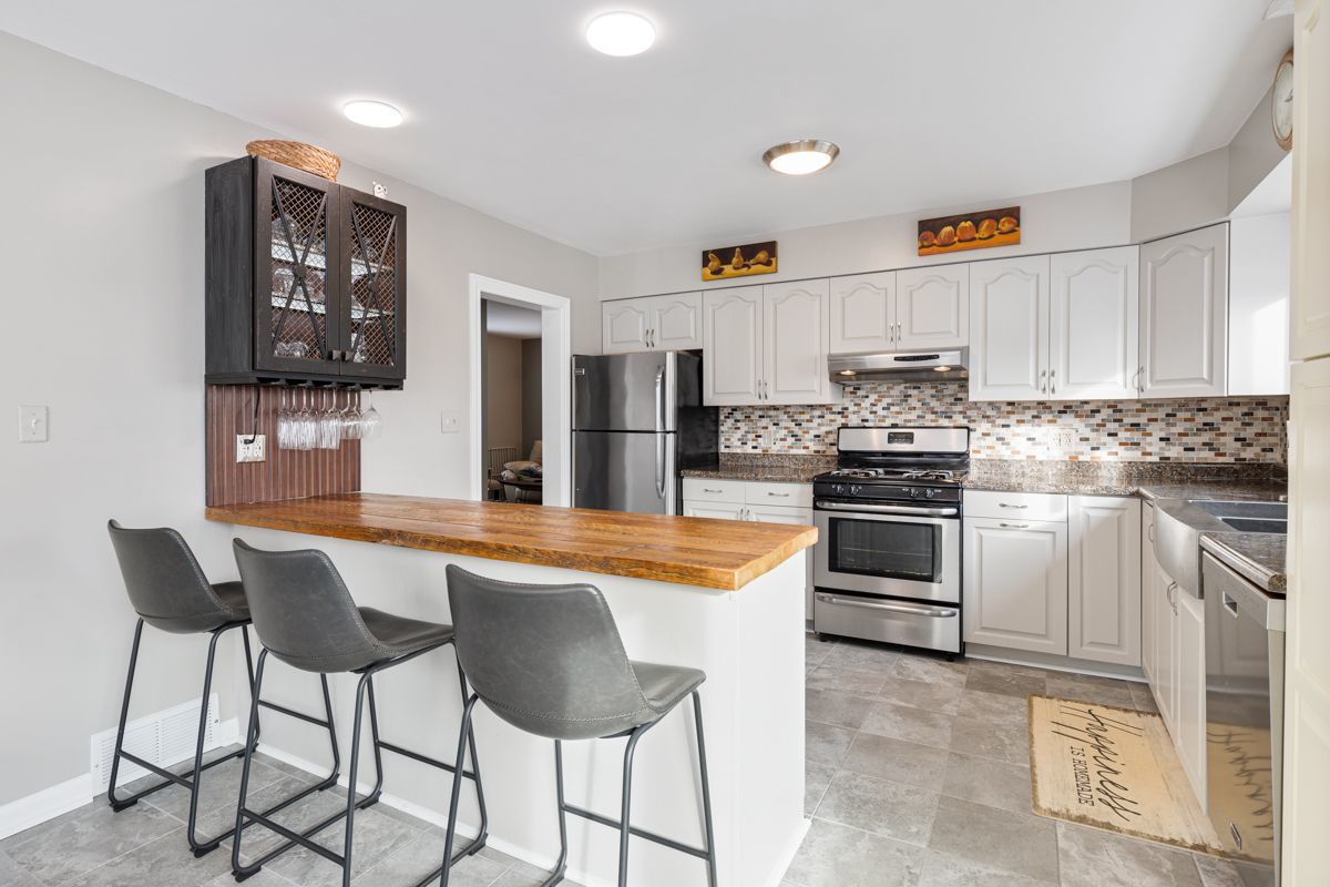 10N849 Rippburger Road Elgin, IL 60124 - Photo 7 of 36 a kitchen with white cabinets and stainless steel appliances