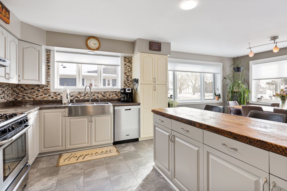 10N849 Rippburger Road Elgin, IL 60124 - Photo 9 of 36 a kitchen with granite countertop a sink and white cabinets