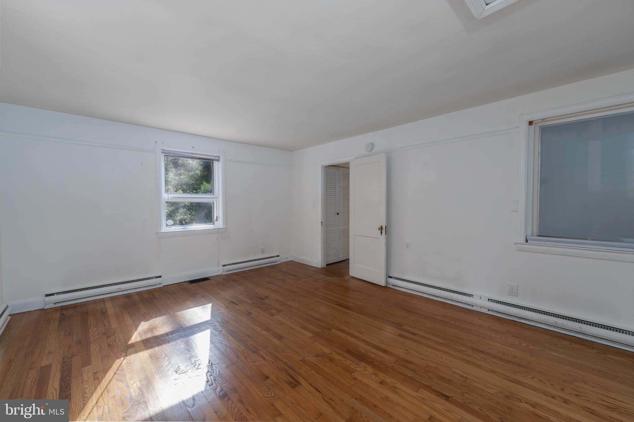 1012 Poplar Hill Road Baltimore, MD 21210 - Photo 25 of 42 a view of an empty room with wooden floor and a window