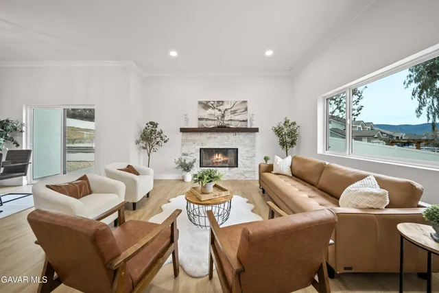 a living room with furniture and a kitchen view