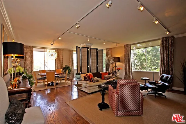 a living room with furniture and floor to ceiling window