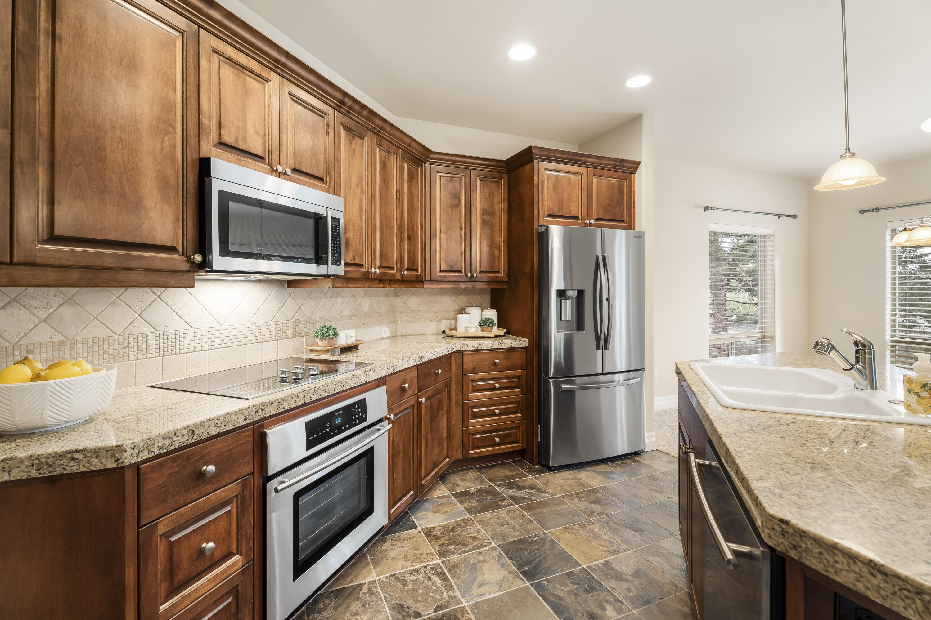 784 Ribbon Falls Road Redmond, OR 97756 - Photo 28 of 79 a kitchen with stainless steel appliances granite countertop a refrigerator stove microwave and sink
