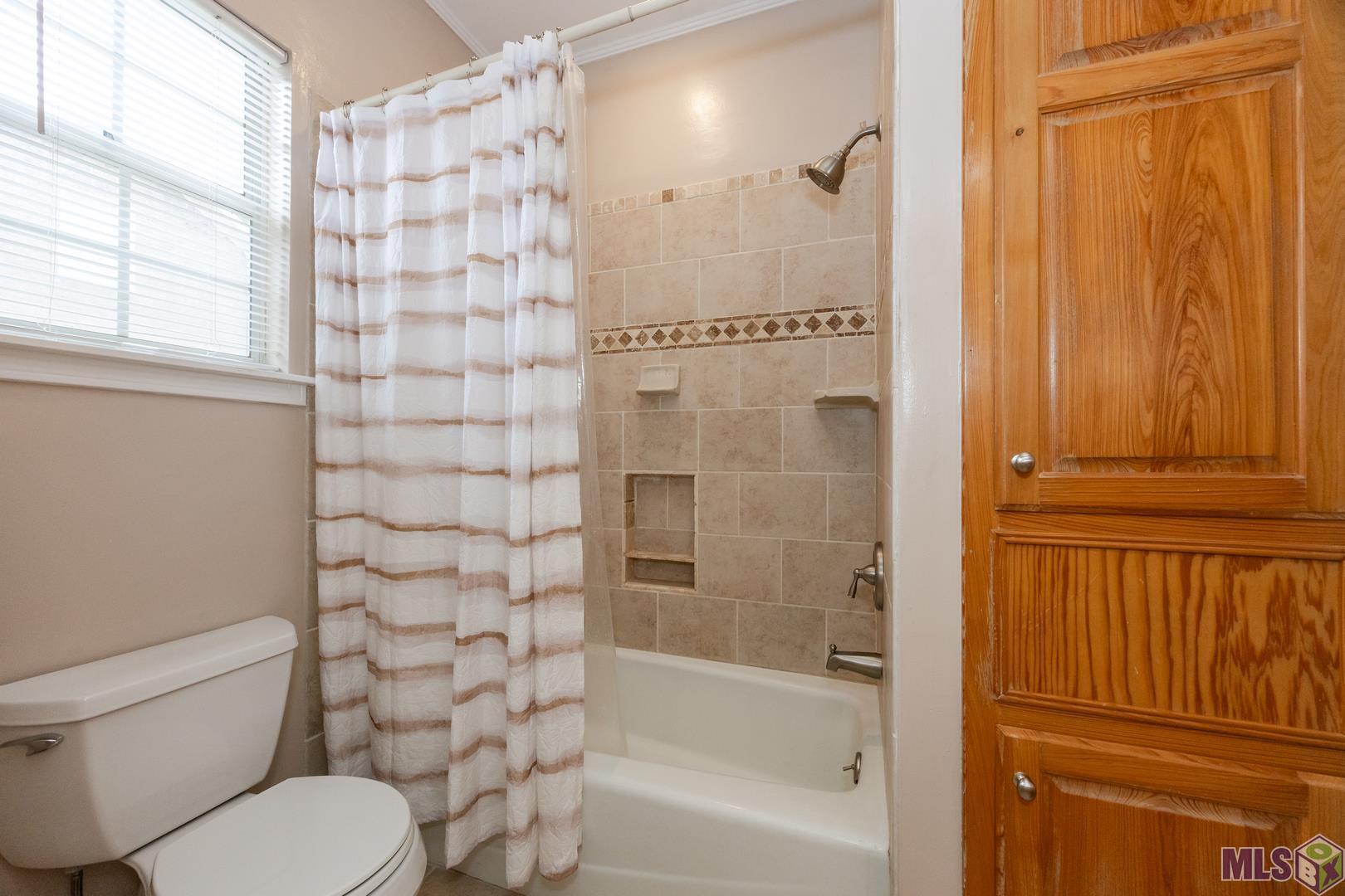 317 West Woodstone Court Baton Rouge, LA 70808 - Photo 20 of 48 Primary Tub/Shower with Cabinets that open to the Laundry Room