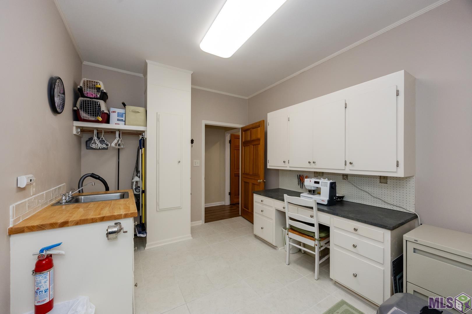 317 West Woodstone Court Baton Rouge, LA 70808 - Photo 24 of 48 Laundry/Hobby Room also has a sink and built in ironing board