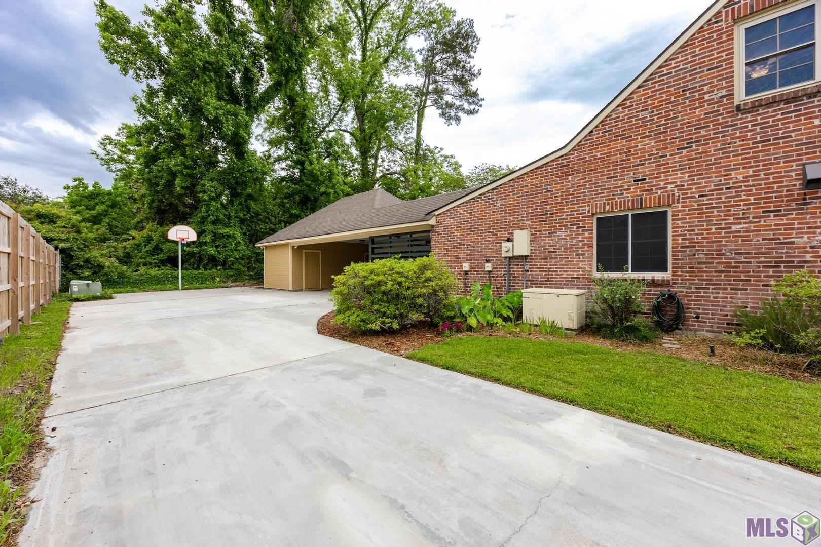 317 West Woodstone Court Baton Rouge, LA 70808 - Photo 44 of 48 Plenty of Parking Plus an Extra Parking Pad beyond the Carport