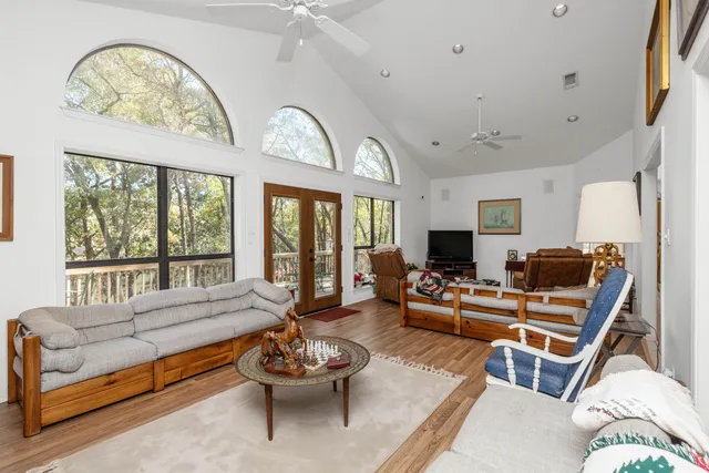 a living room with furniture a fireplace and a large window