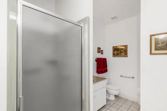 a bathroom with a toilet and a shower