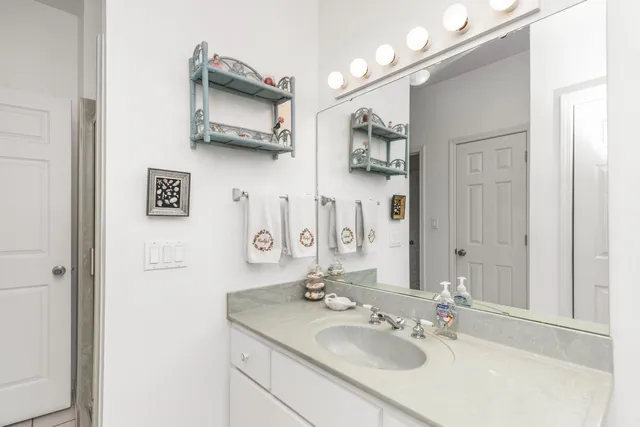 a bathroom with double vanity sink and a mirror