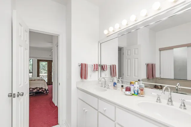 a en suite bathroom with a double vanity sink and a mirror
