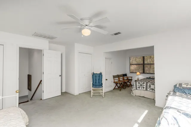 a bedroom with furniture and a window