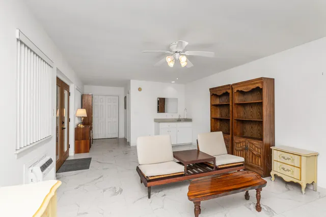 a living room with furniture and white walls