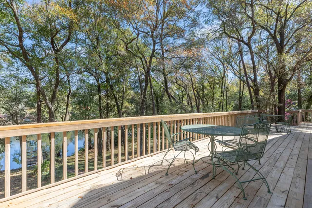 a view of balcony with wooden floor and fence