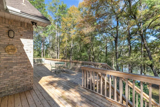 a view of balcony with wooden floor and fence