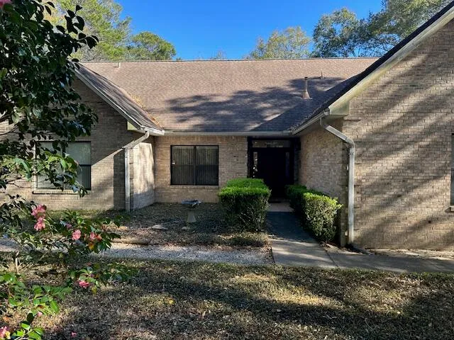 a view of a house with a yard and plants