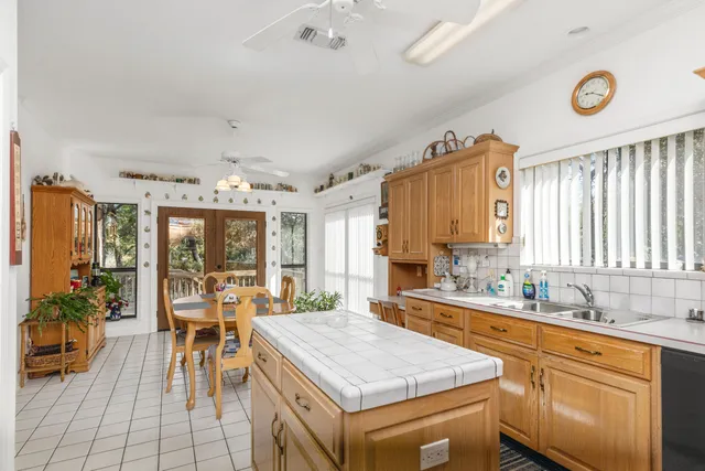 a kitchen with a sink and chairs