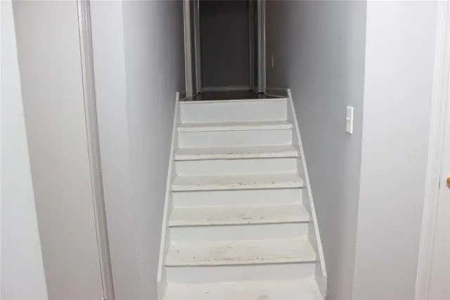a view of staircase with white walls