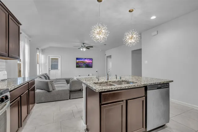 a view of living room kitchen with granite countertop furniture and a flat screen tv