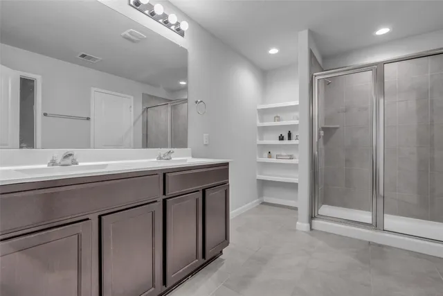 a bathroom with a sink double vanity and a shower