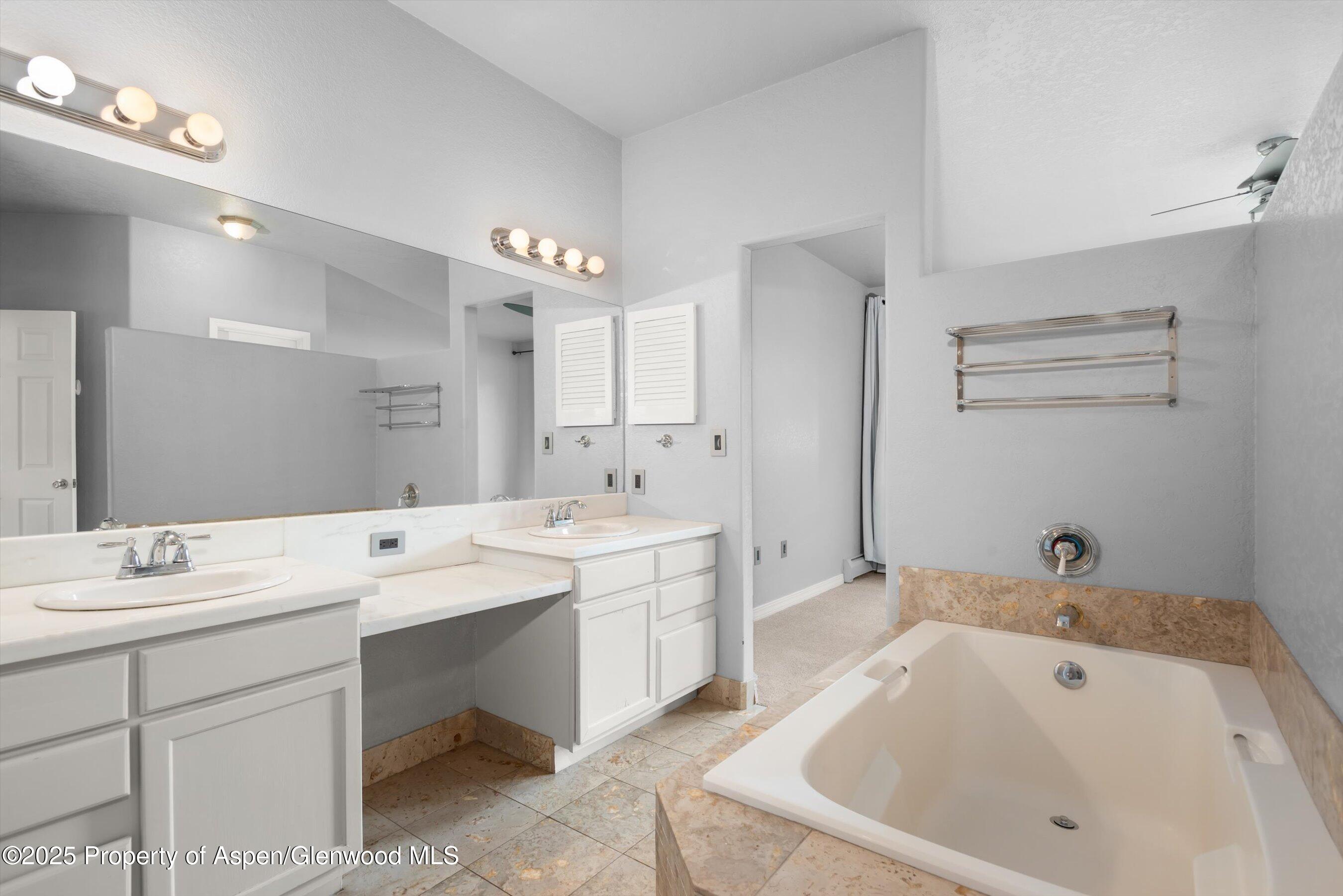 21 Pine Ridge Road Basalt, CO 81621 - Photo 14 of 25 a bathroom with a bathtub a sink and a mirror