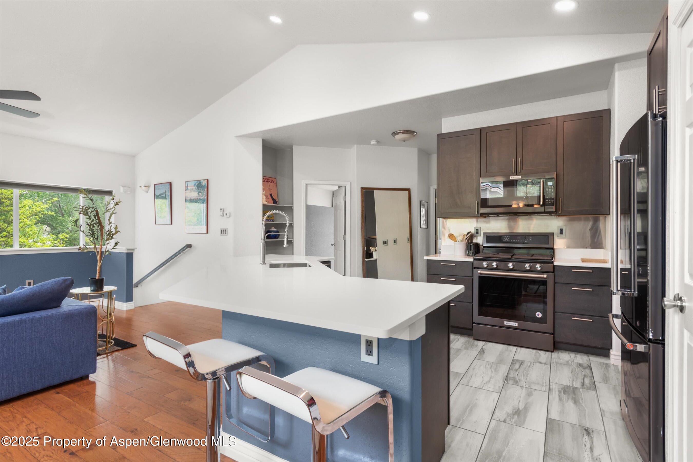 21 Pine Ridge Road Basalt, CO 81621 - Photo 3 of 25 a kitchen with a stove a refrigerator and a stove top oven