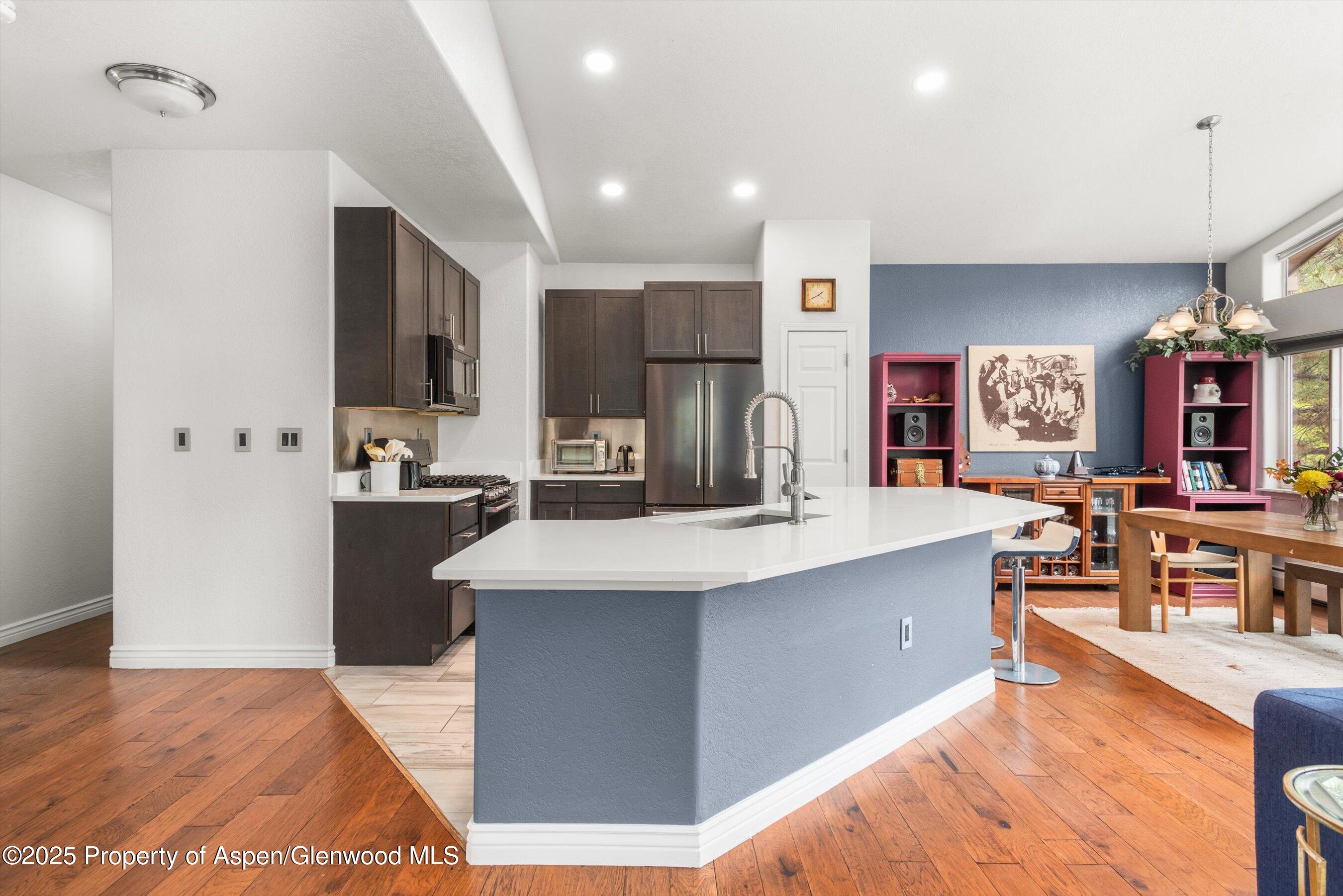 21 Pine Ridge Road Basalt, CO 81621 - Photo 4 of 25 a large kitchen with kitchen island a sink a counter top stainless steel appliances and cabinets