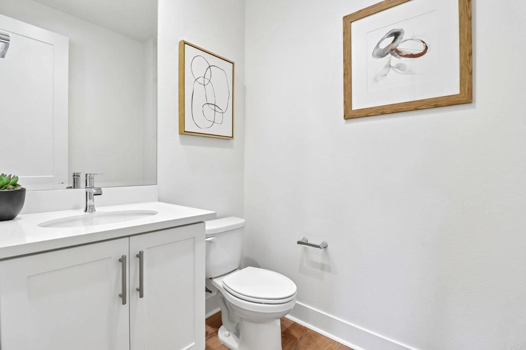 3521 Butler Place Escondido, CA 92027 - Photo 30 of 50 a bathroom with a toilet a sink and mirror