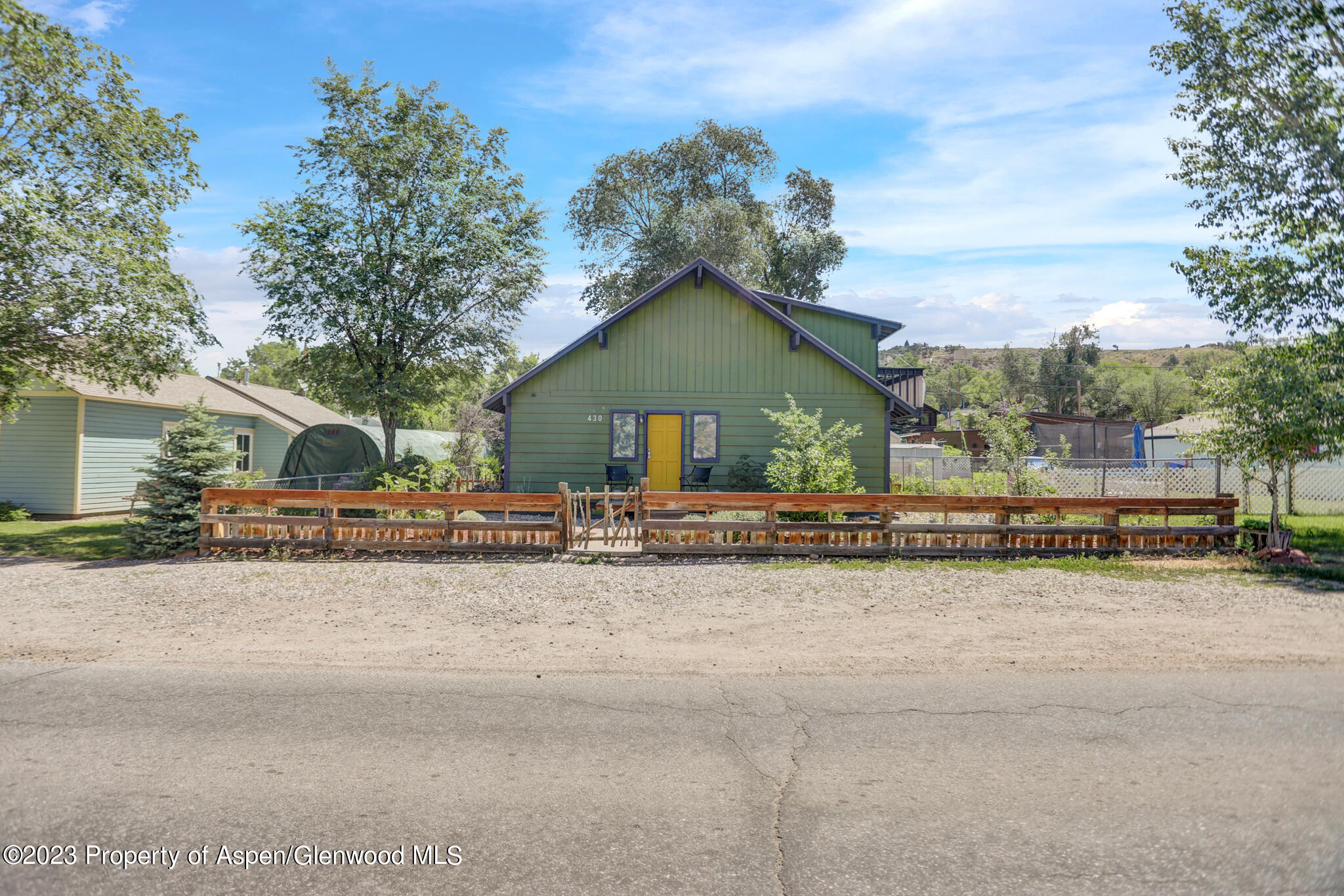 a view of a house with a patio and a yard