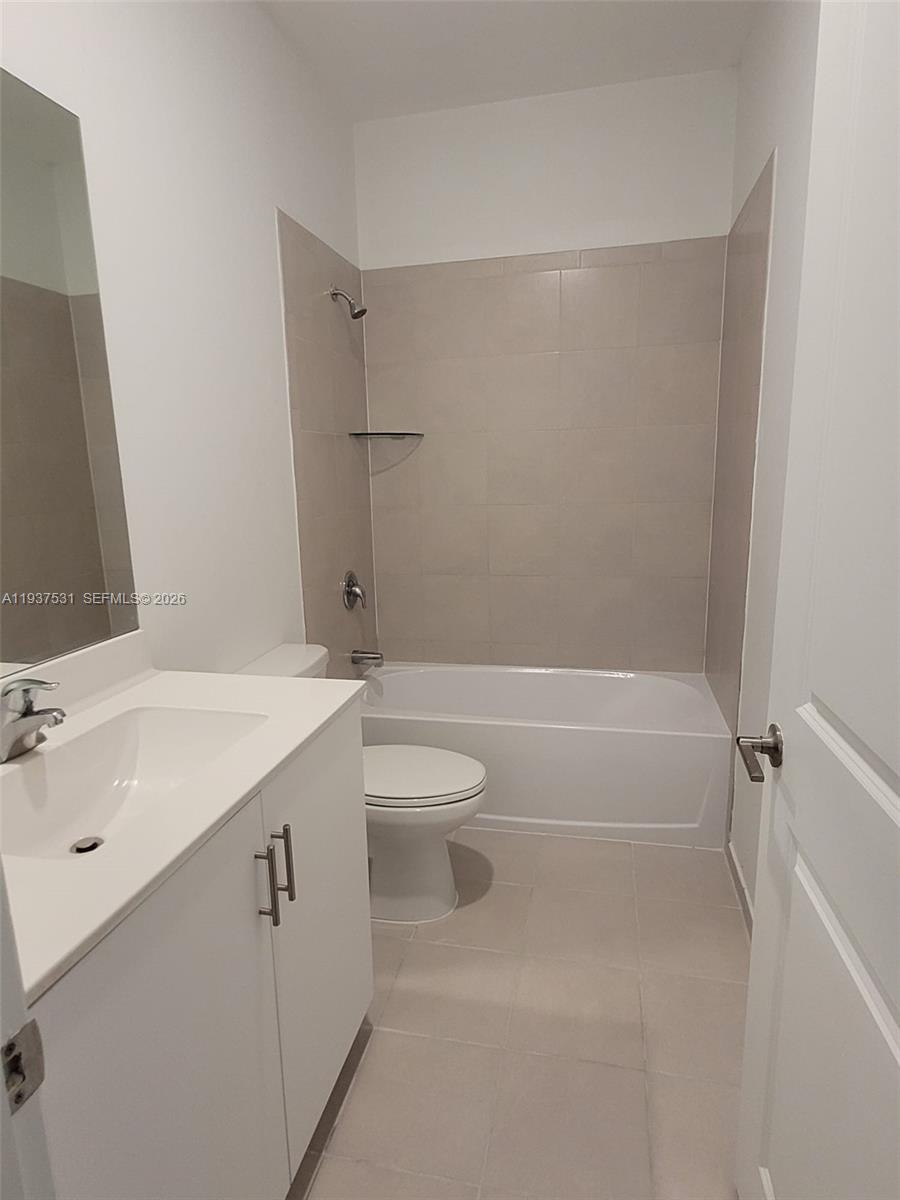 2685 Southeast 13th Street Homestead, FL 33035 - Photo 12 of 18 a bathroom with a granite countertop sink a toilet and shower