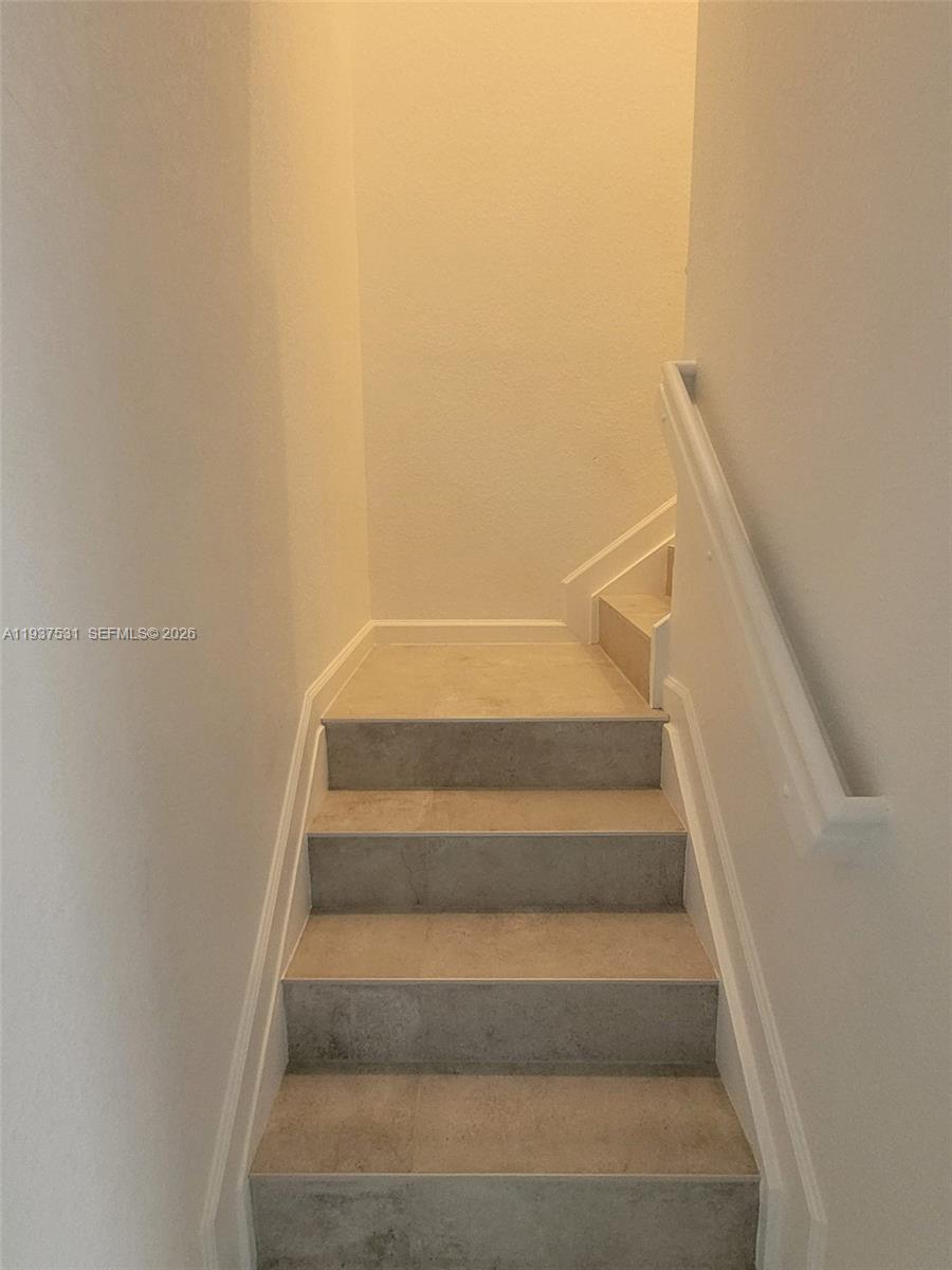 2685 Southeast 13th Street Homestead, FL 33035 - Photo 7 of 18 a view of staircase with white walls