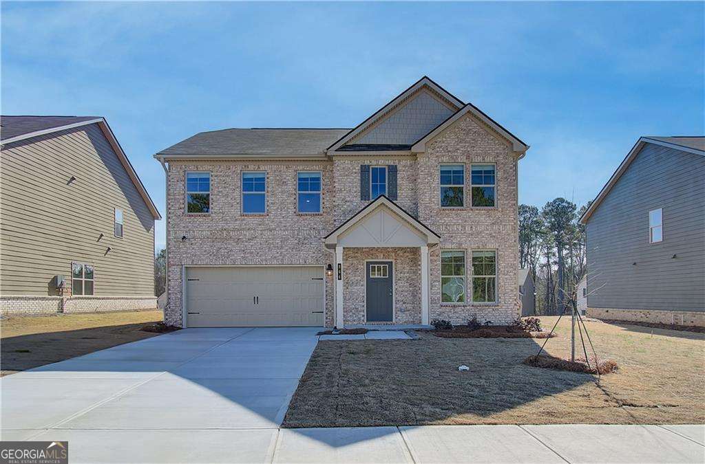 a front view of a house with a yard and garage
