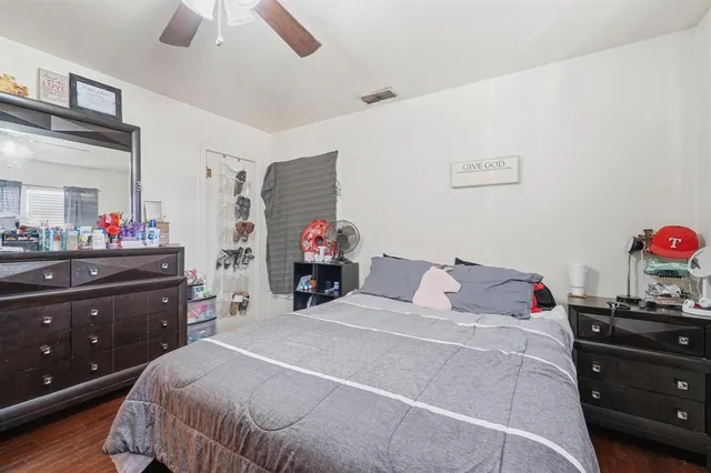 a bedroom with a bed and a dresser