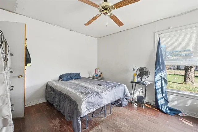 a bedroom with a bed a chandelier and the view of the bathroom
