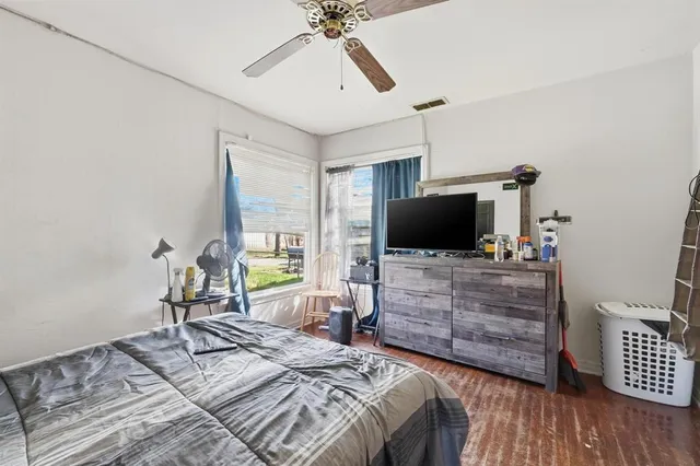a bedroom with a bed and flat screen tv