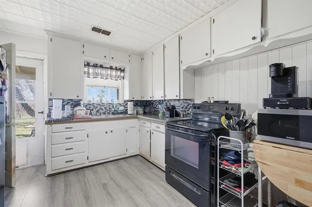 a kitchen with stainless steel appliances granite countertop a stove and cabinets