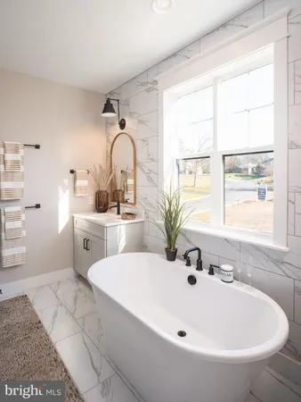 a white bath tub sitting next to a white sink