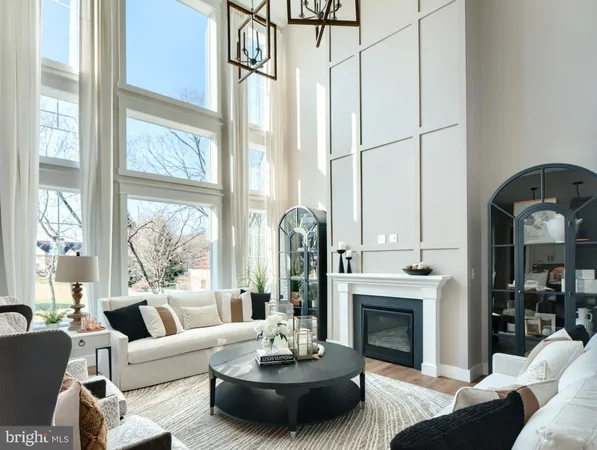 a living room with furniture a fireplace and a large window with garden view