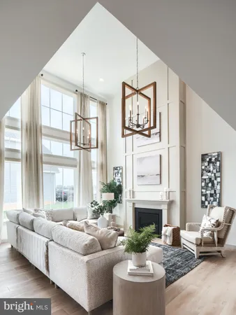 a living room with furniture a fireplace and a large window