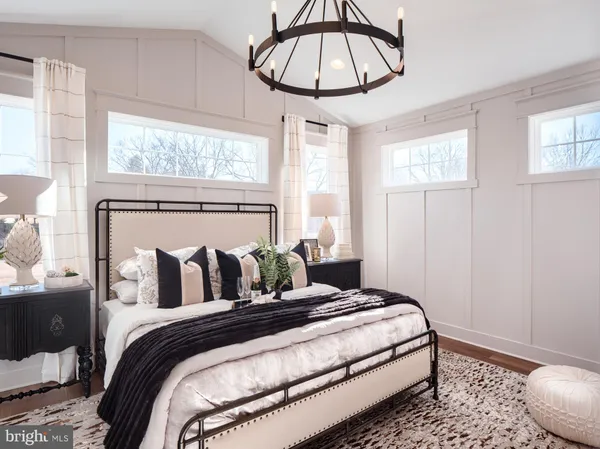 a bedroom with a bed and a chandelier