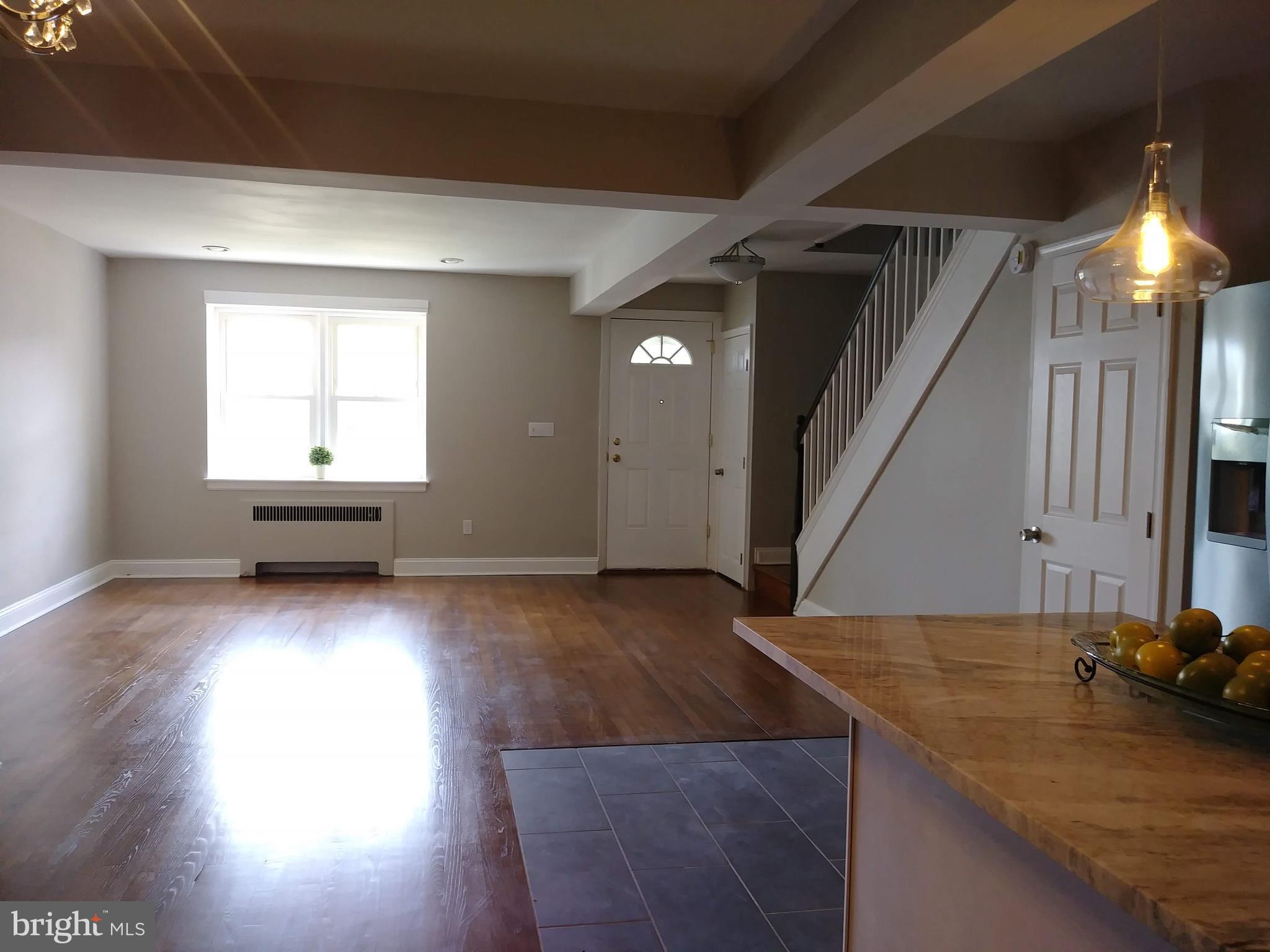3812 Ednor Road Baltimore, MD 21218 - Photo 2 of 22 a view of a livingroom with wooden floor and window