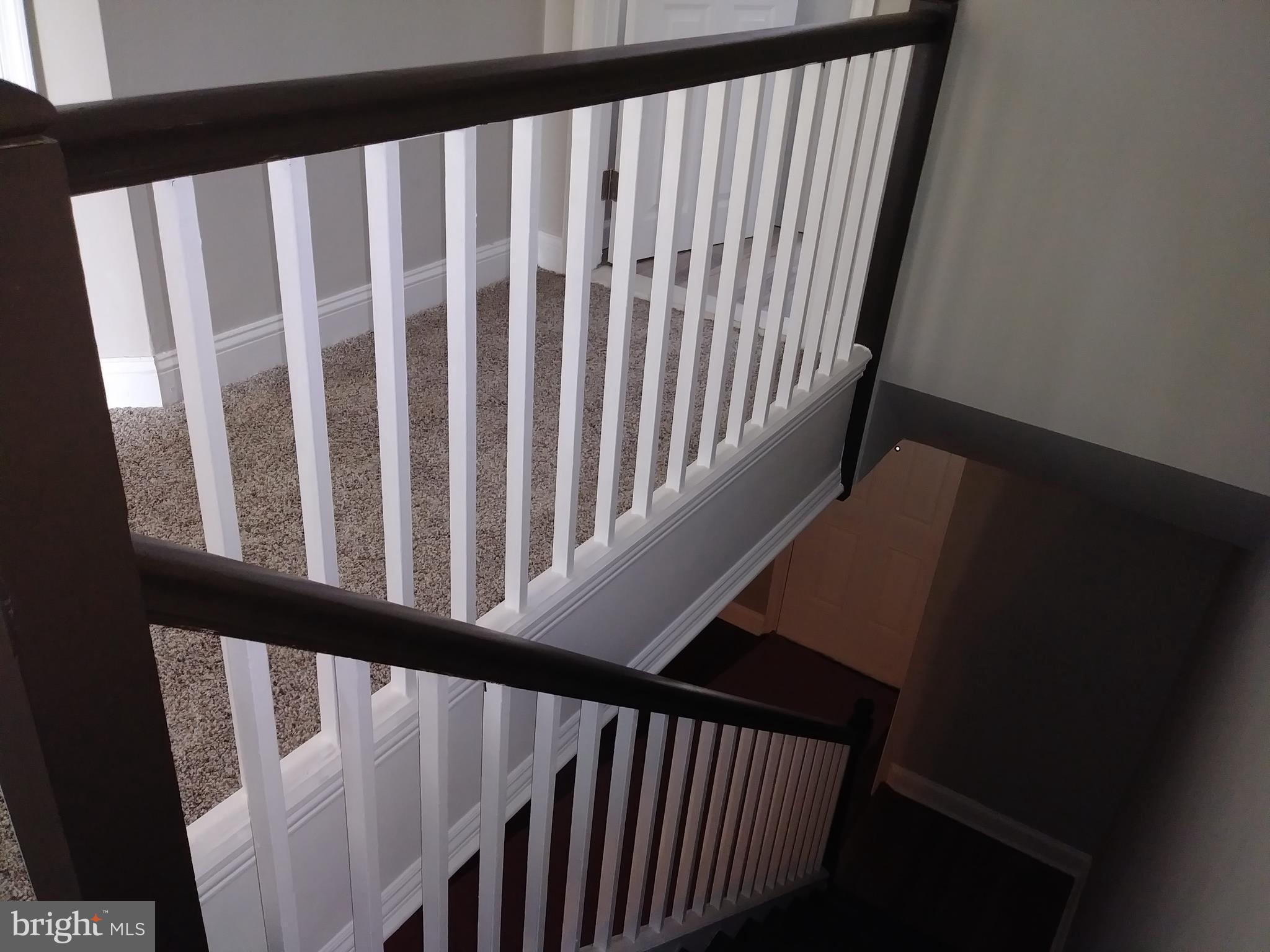 3812 Ednor Road Baltimore, MD 21218 - Photo 14 of 22 a view of staircase with railing and white walls