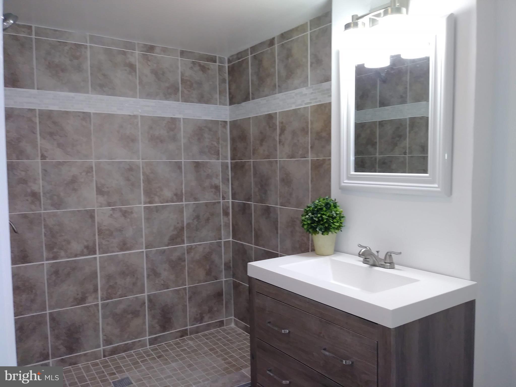3812 Ednor Road Baltimore, MD 21218 - Photo 19 of 22 a bathroom with a sink toilet and shower