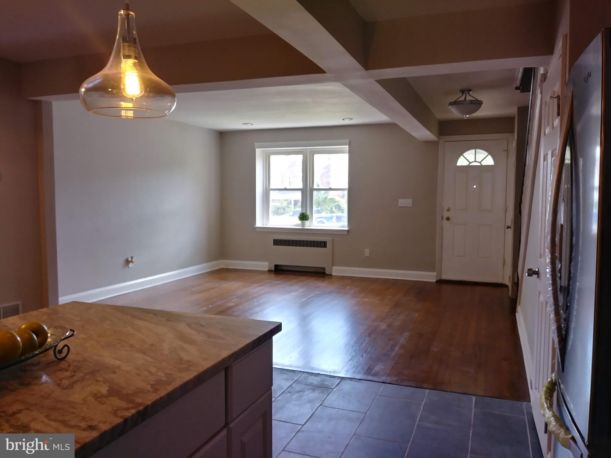 3812 Ednor Road Baltimore, MD 21218 - Photo 3 of 22 an empty room with wooden floor and windows
