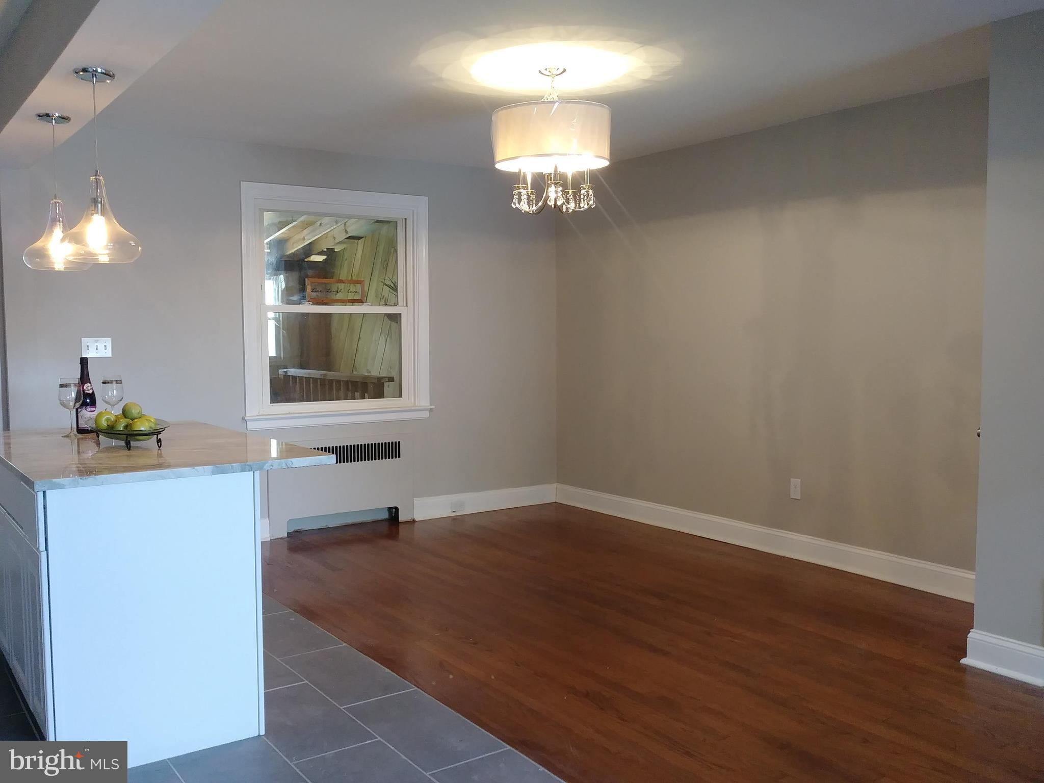 3812 Ednor Road Baltimore, MD 21218 - Photo 6 of 22 a view of empty room with wooden floor and fan