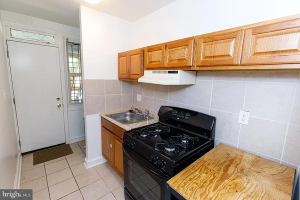 a kitchen with stainless steel appliances granite countertop a stove and a refrigerator